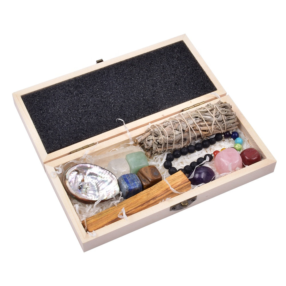 Crystal gift box open showing tumbled stones sage and candle contents